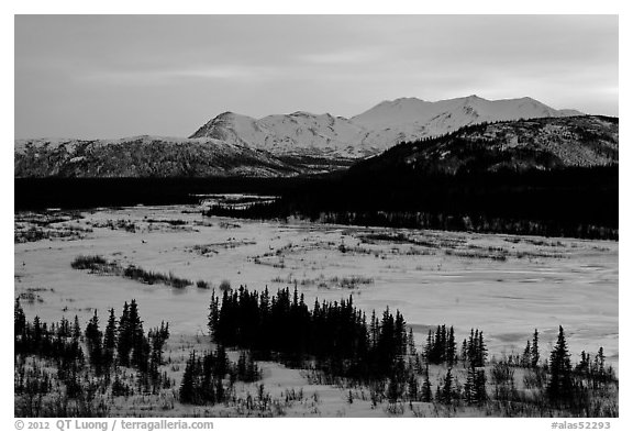 Frozen river and mountains at sunset. Alaska, USA (black and white)