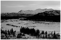 Frozen river and mountains at sunset. Alaska, USA (black and white)