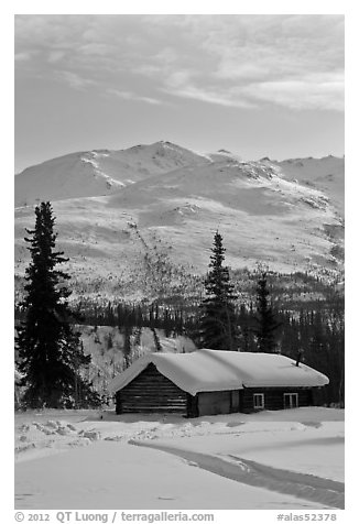 Snowy cabin and mountains. Wiseman, Alaska, USA (black and white)