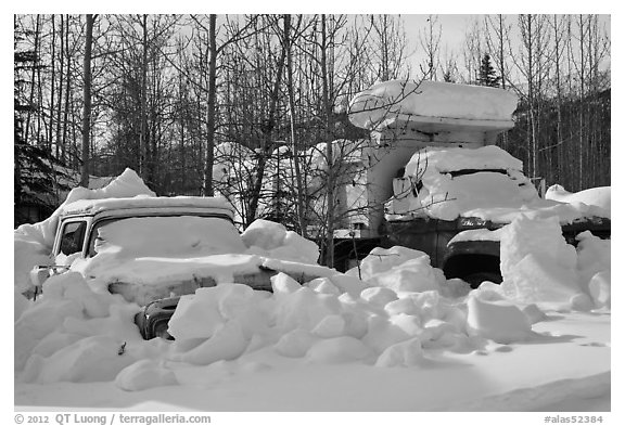 Trucks covered with piles of snow. Wiseman, Alaska, USA (black and white)