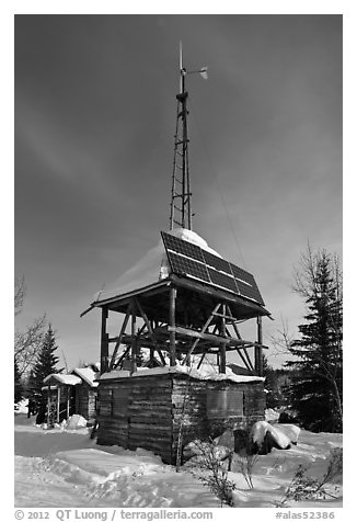 Tower with solar panels and windmill. Wiseman, Alaska, USA (black and white)