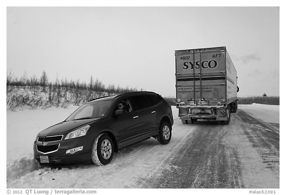 Commercial truck towing car, Dalton Highway. Alaska, USA (black and white)