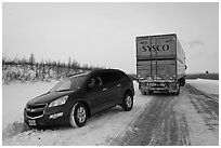 Commercial truck towing car, Dalton Highway. Alaska, USA (black and white)