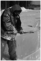 Ice artist carving with saw. Fairbanks, Alaska, USA ( black and white)