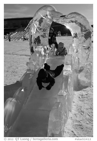 Children slide through ice sculpture. Fairbanks, Alaska, USA (black and white)
