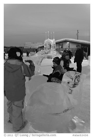 Children playing on ice sculptures, Ice Alaska. Fairbanks, Alaska, USA (black and white)