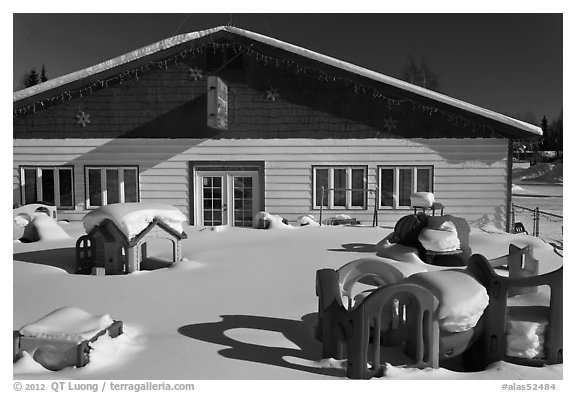 Playground in winter in front of day care. North Pole, Alaska, USA (black and white)