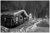 Path in snow and cabins at night. Chena Hot Springs, Alaska, USA (black and white)