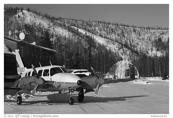 Plane with engine block warmers on frozen runway. Chena Hot Springs, Alaska, USA (black and white)