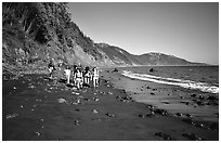 Backpackers on the beach,  Lost Coast. California, USA (black and white)