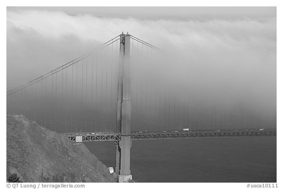 Golden Gate bridge with top covered by fog. San Francisco, California, USA