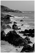 Coastline with pointed rocks and surf, sunset, Garapata State Park. Big Sur, California, USA (black and white)