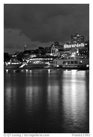 Lights of Ghirardelli Square sign reflected in Aquatic Park. San Francisco, California, USA (black and white)