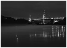 Golden Gate Bridge reflected in wet sand, blue hour. San Francisco, California, USA (black and white)