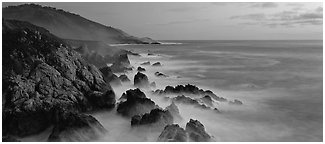 Seascape with pastel colors, rocks, and surf. Big Sur, California, USA (Panoramic black and white)