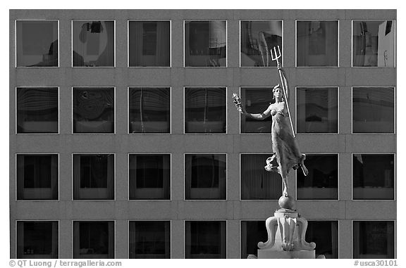 Statue on Admiral Dewey memorial column in front of modern building. San Francisco, California, USA