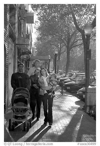 Family strolls on the sidewalk of University Avenue. Palo Alto,  California, USA