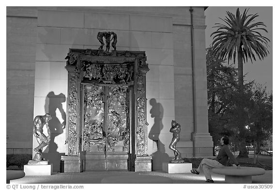 Visitor contemplating Rodin's Gates of Hell in the Rodin sculpture garden. Stanford University, California, USA (black and white)