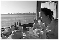 Woman eating clam chowder in a sourdough bread bowl. Santa Cruz, California, USA (black and white)