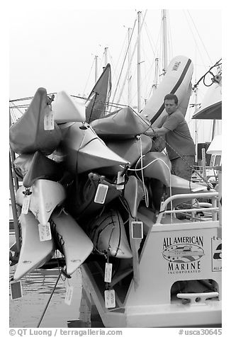 Sea Kayaks attached to a tour boat. California, USA (black and white)