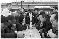 Vietnamese immigrants at a Chinese chess game. San Jose, California, USA (black and white)