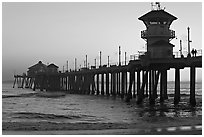 The 1853 ft Huntington Pier at sunset. Huntington Beach, Orange County, California, USA (black and white)