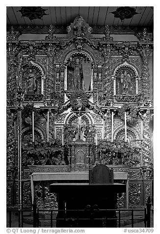 350 year old retablo made of hand-carved wood with a gold leaf overlay. San Juan Capistrano, Orange County, California, USA (black and white)