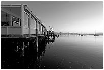 Waterfront restaurant in Morro Bay harbor, sunset. Morro Bay, USA ( black and white)