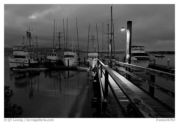 Deck and boats at night. Morro Bay, USA (black and white)