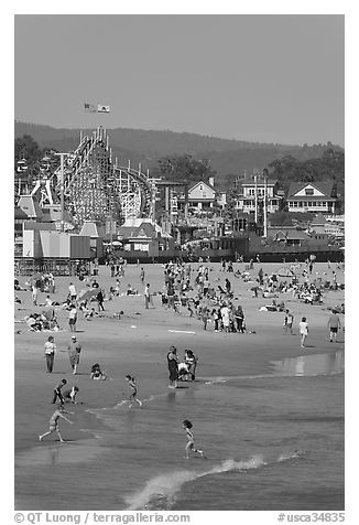 Children, beach, and boardwalk. Santa Cruz, California, USA (black and white)