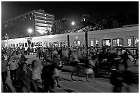 Crowds and light rail on San Carlos Avenue at night, Independence Day. San Jose, California, USA ( black and white)