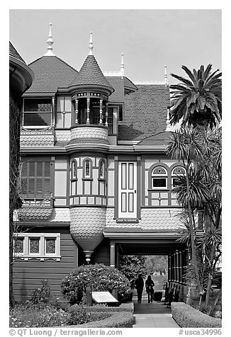Mansion wing with door opening to a one-story drop. Winchester Mystery House, San Jose, California, USA (black and white)