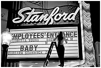 Neon signs and movie title being rearranged, Stanford Theater. Palo Alto,  California, USA ( black and white)
