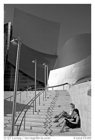 Women sunning on the steps of the entrance of the Walt Disney Concert Hall. Los Angeles, California, USA (black and white)