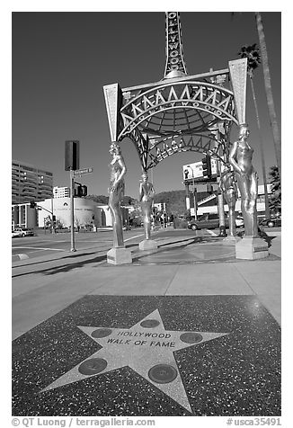 Star from the Hollywood walk of fame and gazebo with statues of actresses. Hollywood, Los Angeles, California, USA