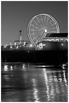 Ferris Wheel in motion at nightfall. Santa Monica, Los Angeles, California, USA ( black and white)