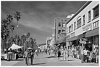 Couple strolling on Venice Boardwalk. Venice, Los Angeles, California, USA ( black and white)