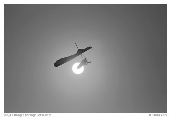 Hang glider in front of setting sun. San Francisco, California, USA (black and white)