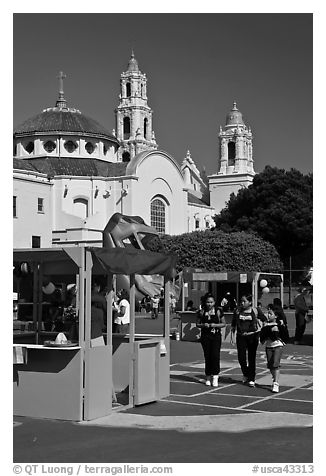 School fair booth, children, and Mission Dolores in the background. San Francisco, California, USA (black and white)