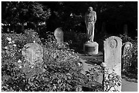 Gravestones and statue, Mission Dolores. San Francisco, California, USA (black and white)