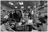 Indian family inside popular pizza restaurant, Haight-Ashbury district. San Francisco, California, USA (black and white)