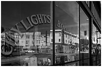 City Light Bookstore window glass and city reflections, North Beach. San Francisco, California, USA (black and white)