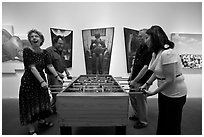 Playing soccer table game in art gallery, Bergamot Station. Santa Monica, Los Angeles, California, USA (black and white)