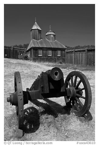 Cannon and Russian chapel inside Fort Ross. Sonoma Coast, California, USA (black and white)