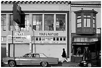 Old car and sidewalk, Mission Street, Mission District. San Francisco, California, USA (black and white)
