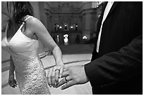Newly wed couple holds hands, showing ring, City Hall. San Francisco, California, USA ( black and white)