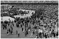Audience and graduates mingling in stadium after commencement. Stanford University, California, USA ( black and white)