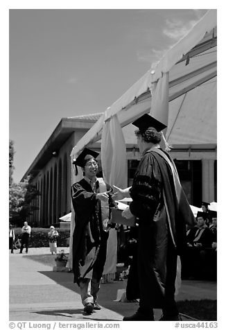 Student receiving handshake prior diploma award. Stanford University, California, USA (black and white)