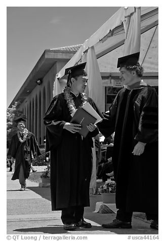Graduate wearing lei presented with diploma. Stanford University, California, USA (black and white)