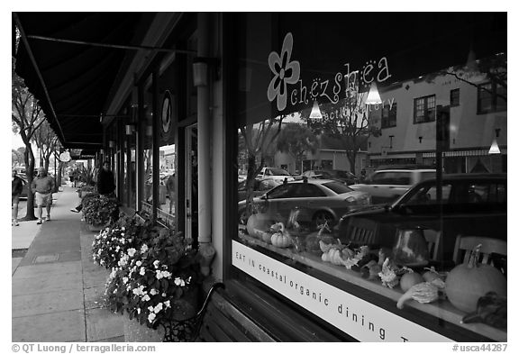 Main street reflected in storefront. Half Moon Bay, California, USA (black and white)